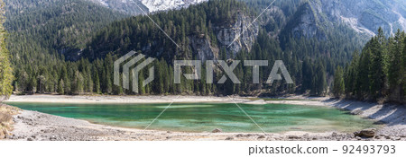 Abundant alpine fauna and jaw-dropping mountain-backdrop reflecting in crystal waters of Tovel lake 92493793