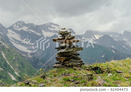 pyramid stones on snow mountain peaks 92494473