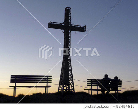 Summit cross of Hochgrat mountain at sunset, Bavaria, Germany 92494615