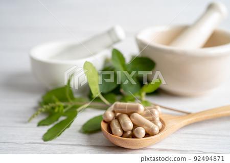 Alternative medicine herbal organic capsule drug with herbs leaf natural supplements for healthy good life. Alternative medicine herbal organic capsule drug with herbs leaf natural supplements for healthy good life. 92494871