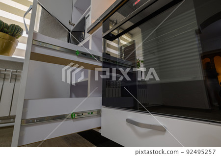 Modern kitchen closeup to details with doors open 92495257