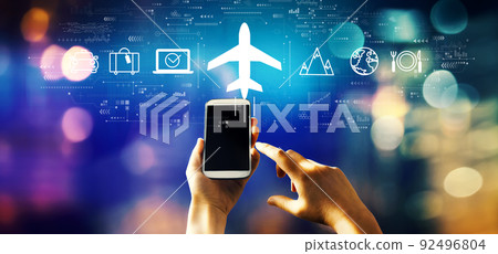 Flight ticket booking concept with person using smartphone Flight ticket booking concept with person using smartphone 92496804