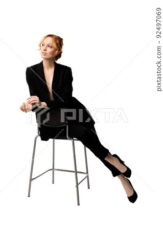 Delighted young businesswoman sitting on chair sexy and dream concept 92497069