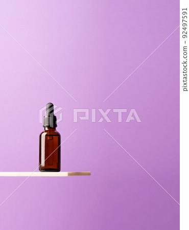 Bottle of cosmetic product, dark glass with pipette creative marble shelf, podium purple background Bottle of cosmetic product, dark glass with pipette creative marble shelf, podium purple background 92497591