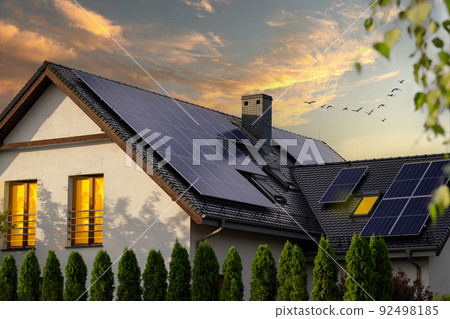 Solar photovoltaic panels on a house roof. Sunset. Solar photovoltaic panels on a house roof. Sunset. 92498185