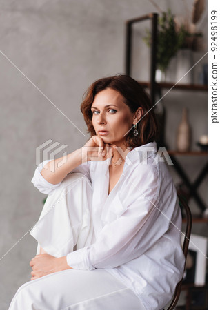 attractive brunette woman in a white shirt. decorative and care cosmetics. attractive brunette woman in a white shirt. decorative and care cosmetics. 92498199
