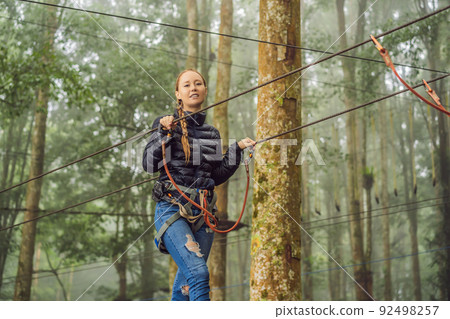 Positive woman spending her free time in the adventure park 92498257