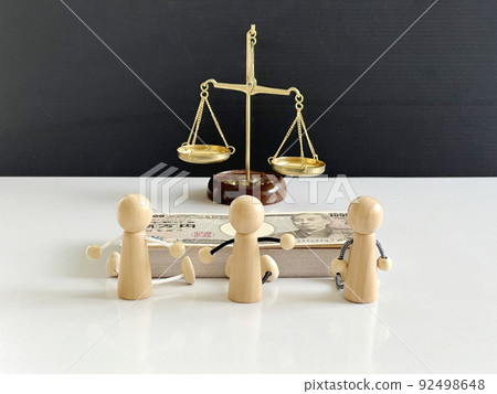 Balance, wad of bills and 3 dolls 92498648