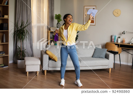 Black Female Singing Holding Rag And Detergent Spray Cleaning Home 92498860