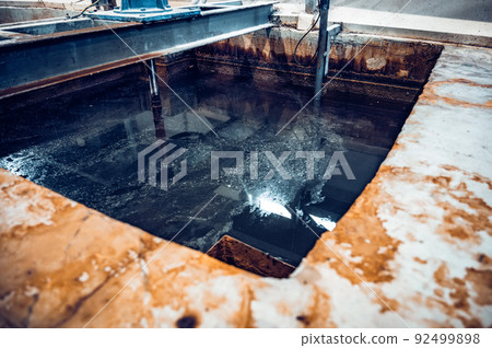 Tank with waste water in steel plant workshop 92499898
