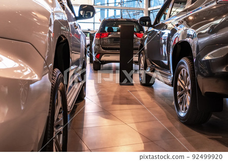 Brand new cars at the dealer showroom Brand new cars at the dealer showroom 92499920