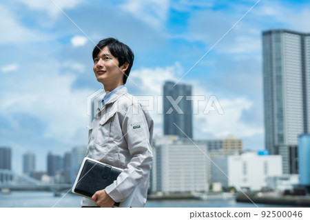 An engineer who poses under a refreshing blue sky An engineer who poses under a refreshing blue sky 92500046