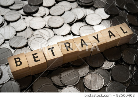 Image of betrayal | Blocks and coins with "BE TRAYAL" written on them 92500408