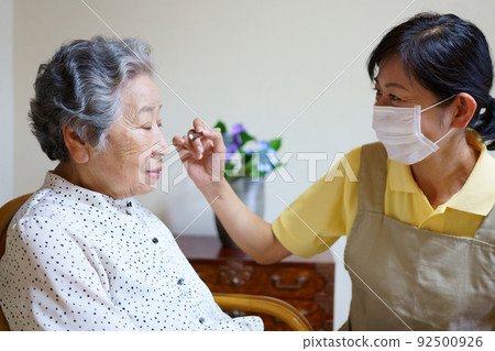 Elderly woman getting makeup Elderly woman getting makeup 92500926