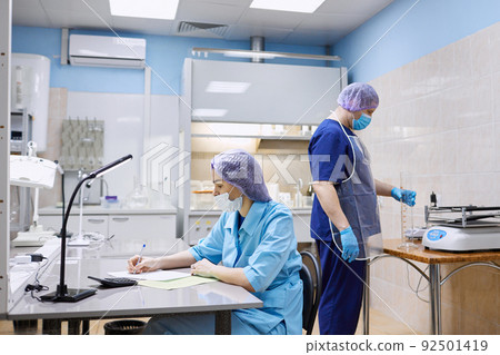 Scientists work in the laboratory. Remove the biomaterial from the freezer Scientists work in the laboratory. Remove the biomaterial from the freezer 92501419