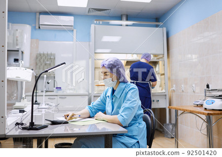 Scientists work in the laboratory. Remove the biomaterial from the freezer Scientists work in the laboratory. Remove the biomaterial from the freezer 92501420