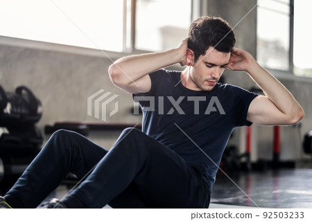 Sportsman or Handsome man exercising doing sit up abdominal exercise in gym 92503233