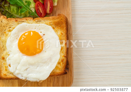 bread toasted with cheese and fried egg 92503877