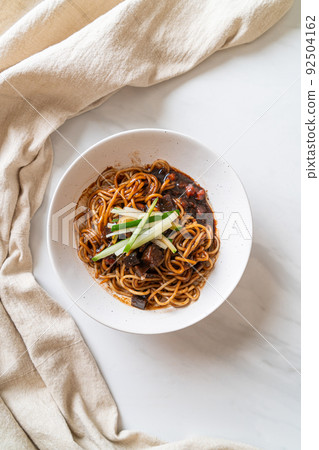 Jajangmyeon or JJajangmyeon is Korean Noodle with Black Sauce 92504162