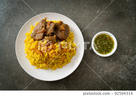 Beef Biryani or Curried rice and beef - Thai-Muslim version of Indian biryani, with fragrant yellow rice and beef Beef Biryani or Curried rice and beef - Thai-Muslim version of Indian biryani, with fragrant yellow rice and beef 92504314