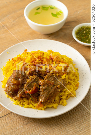 Beef Biryani or Curried rice and beef - Thai-Muslim version of Indian biryani, with fragrant yellow rice and beef Beef Biryani or Curried rice and beef - Thai-Muslim version of Indian biryani, with fragrant yellow rice and beef 92504320