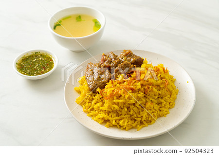 Beef Biryani or Curried rice and beef - Thai-Muslim version of Indian biryani, with fragrant yellow rice and beef Beef Biryani or Curried rice and beef - Thai-Muslim version of Indian biryani, with fragrant yellow rice and beef 92504323