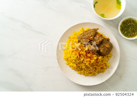 Beef Biryani or Curried rice and beef - Thai-Muslim version of Indian biryani, with fragrant yellow rice and beef Beef Biryani or Curried rice and beef - Thai-Muslim version of Indian biryani, with fragrant yellow rice and beef 92504324