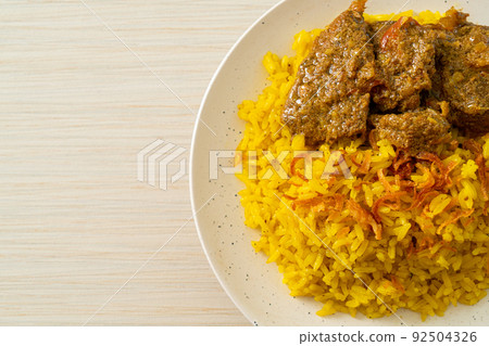 Beef Biryani or Curried rice and beef - Thai-Muslim version of Indian biryani, with fragrant yellow rice and beef Beef Biryani or Curried rice and beef - Thai-Muslim version of Indian biryani, with fragrant yellow rice and beef 92504326