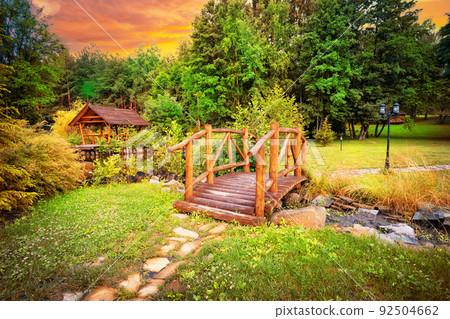 Wooden bridge in park at sunset 92504662