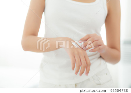 Closeup hands of woman applying moisturizer cream and lotion with hands for skin protection. 92504788