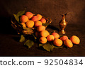Image Decoration from fresh apricots. Still life, nature morte in dramatically dark setting and background. 92504834