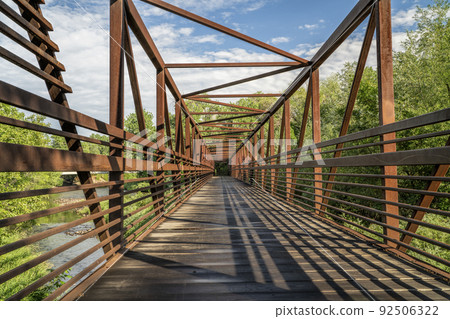 footbridge and bike trail over a river footbridge and bike trail over a river 92506322