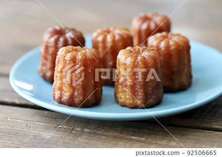 Mini canelés, French pastries, arranged on a plate Mini canelés, French pastries, arranged on a plate 92506665