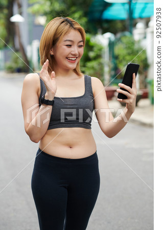 Sportswoman Video Calling Fitness Trainer 92507938