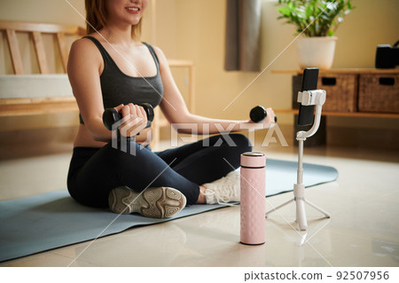 Woman Following Tutorial on Smartphone Woman Following Tutorial on Smartphone 92507956