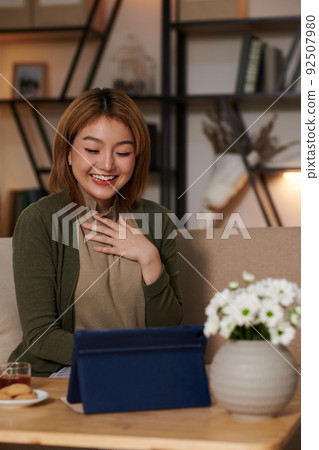 Woman Video Calling Her Friend Woman Video Calling Her Friend 92507980