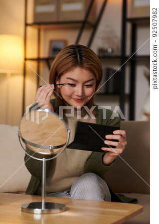 Woman Doing Makeup before Work 92507982