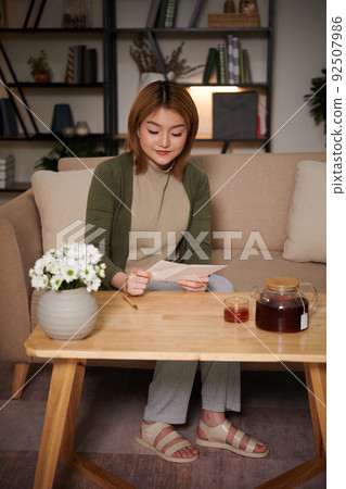 Woman Reading Letter from Friend Woman Reading Letter from Friend 92507986
