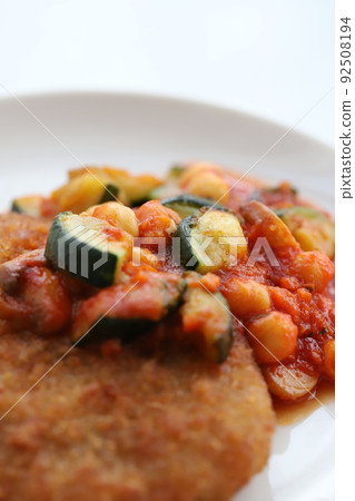 Pork cutlet with chunky vegetables and tomato sauce Pork cutlet with chunky vegetables and tomato sauce 92508194