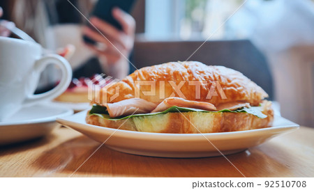 Croissant and meat on a girl's table at lunchtime. Croissant and meat on a girl's table at lunchtime. 92510708