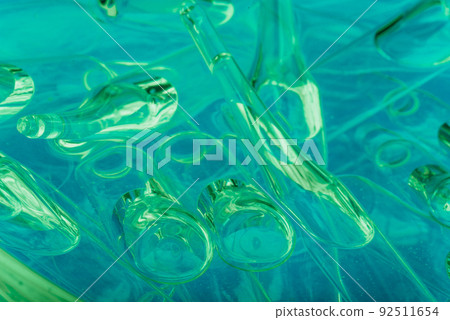 Glass medical ampoule vial for injection. Medicine is liquid sodium chloride with of aqueous solution in ampulla. Close up. Bottles ampule multicolor. Glass medical ampoule vial for injection. Medicine is liquid sodium chloride with of aqueous solution in ampulla. Close up. Bottles ampule multicolor. 92511654