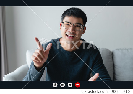 Portrait happy man working at home by video conference meeting talking and looking at camera. greeting family or friends Portrait happy man working at home by video conference meeting talking and looking at camera. greeting family or friends 92511710