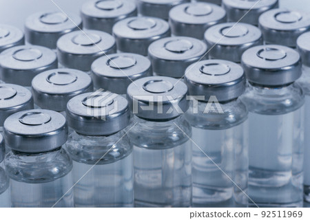 Glass medical ampoule vial for injection. Medicine is dry white drug penicillin powder or liquid with of aqueous solution in ampulla. Close up. Glass medical ampoule vial for injection. Medicine is dry white drug penicillin powder or liquid with of aqueous solution in ampulla. Close up. 92511969