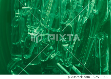 Glass medical ampoule vial for injection. Medicine is liquid sodium chloride with of aqueous solution in ampulla. Close up. Bottles ampule multicolor. Glass medical ampoule vial for injection. Medicine is liquid sodium chloride with of aqueous solution in ampulla. Close up. Bottles ampule multicolor. 92511990