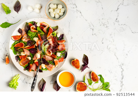 Freshly made Chopped Salad in Italian restaurant, mozzarella, figs, prosciutto or jamon. Copy space Freshly made Chopped Salad in Italian restaurant, mozzarella, figs, prosciutto or jamon. Copy space 92513544