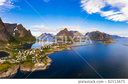 Reine fishing village surrounded by high mountains and fjords on Lofoten islands Reine fishing village surrounded by high mountains and fjords on Lofoten islands 92513675