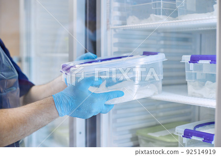 The scientist takes samples of materials for experiments out of the refrigerator The scientist takes samples of materials for experiments out of the refrigerator 92514919