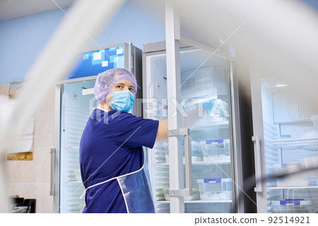 The scientist takes samples of materials for experiments out of the refrigerator 92514921