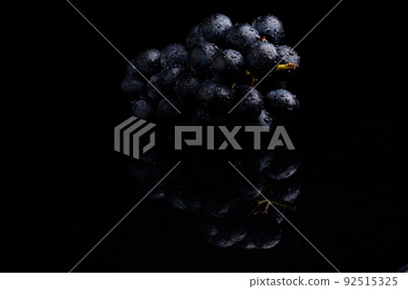 Photo taken on a black reflective background of large grapes Photo taken on a black reflective background of large grapes 92515325