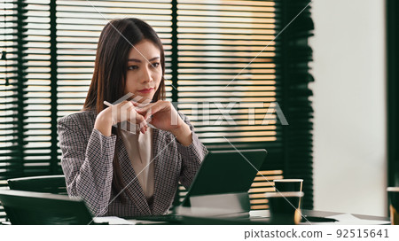Pleasant young businesswoman using digital tablet, web surfing information or reading business email Pleasant young businesswoman using digital tablet, web surfing information or reading business email 92515641
